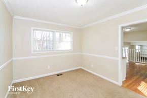 Smyrna house for rent - a living room with a carpeted floor and a window