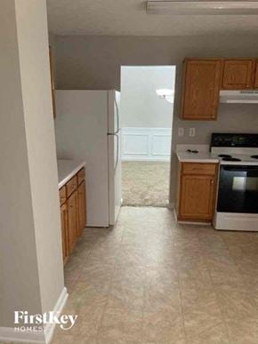 Buford house for rent - a kitchen with a stove and a refrigerator