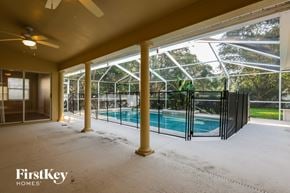 Lakeland house for rent - A room with a pool and a ceiling fan.