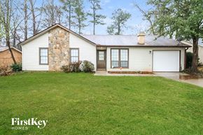 Stone Mountain house for rent - the front of a white house with a lawn and a garage