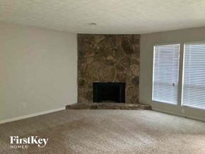 Stone Mountain house for rent - an empty living room with a stone fireplace