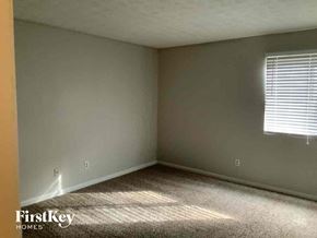 Stone Mountain house for rent - a bedroom with a window and a carpeted floor