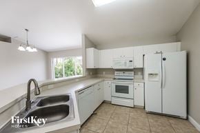 Lehigh Acres house for rent - a kitchen with white appliances and a sink