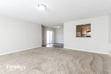 Indianapolis house for rent - a spacious living room with white walls and carpet