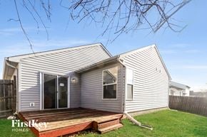 Indianapolis house for rent - the exterior of a white house with a porch and a wooden deck