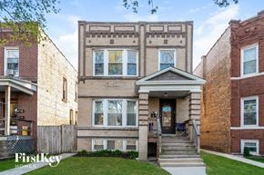 Chicago house for rent - the front of a brick house with stairs and a porch