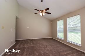 Spring house for rent - A room with a ceiling fan and carpeted floor.