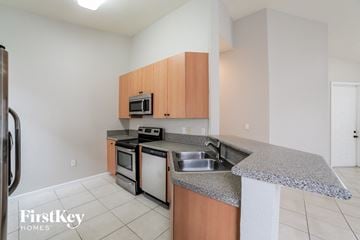 Homestead house for rent - a kitchen with granite counter tops and stainless steel appliances