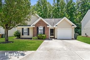 Greensboro house for rent - a white and brick house with a white garage door