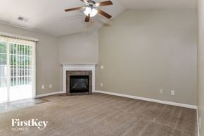Greensboro house for rent - the living room with fireplace and ceiling fan
