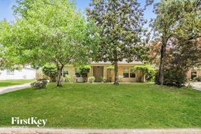 Humble house for rent - A house with a lawn and trees in front of it.