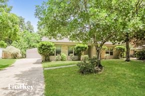 Humble house for rent - A house with a lawn and trees in front of it.