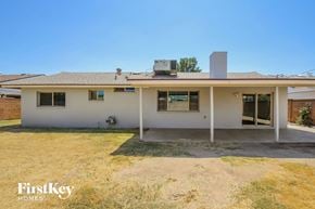 Phoenix house for rent - A house with a white exterior and a brown roof is for sale.