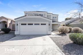 San Tan Valley house for rent - A modern house with a white garage door is for sale.