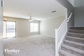 San Tan Valley house for rent - A spacious room with a staircase leading to the upper floor.