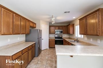 San Tan Valley house for rent - A kitchen with wooden cabinets and a refrigerator.