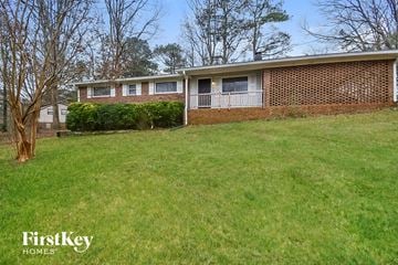 Douglasville house for rent - a brick house with a lawn in front of it