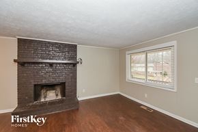 Douglasville house for rent - the living room of a house with a brick fireplace