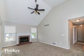 Powder Springs house for rent - the living room has a fireplace and a ceiling fan