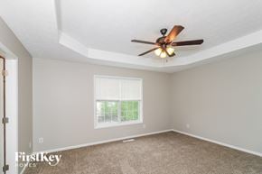 Powder Springs house for rent - a bedroom with a ceiling fan and a window