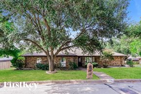 Fort Worth house for rent - A house with a tree in front of it.