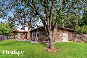 Fort Worth house for rent - A tree in a grassy area in front of a house.