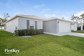 Port St. Lucie house for rent - a white house with a lawn and a garage