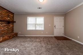 Conyers house for rent - A room with a brick fireplace and a carpeted floor.