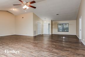 Coral Springs house for rent - A spacious room with wooden floors and a ceiling fan.