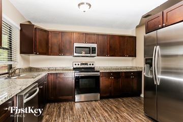 Coral Springs house for rent - A kitchen with wooden cabinets and stainless steel appliances.