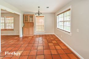 Spring house for rent - A room with a tile floor and a chandelier.