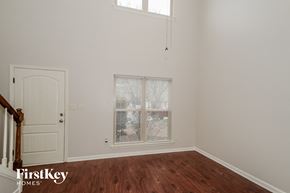 Chelsea house for rent - a bedroom with white walls and a window and a door