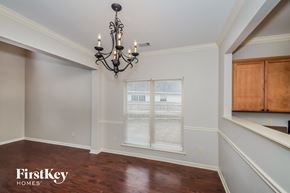 Chelsea house for rent - a dining room with a large window and a chandelier