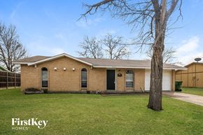 Garland house for rent - A brick house with a tree in front of it.
