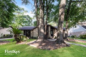 Humble house for rent - a house with trees in front of it