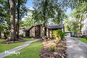 Humble house for rent - a house with a sidewalk and trees in front of it