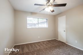 Humble house for rent - a bedroom with a ceiling fan and a window