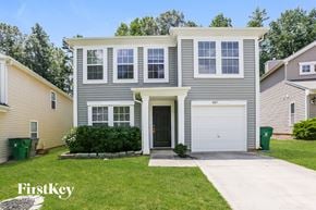 Charlotte house for rent - a with a white garage door and a lawn