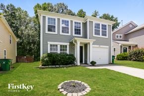 Charlotte house for rent - a home with a lawn and a sidewalk in front of it