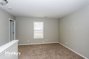 Charlotte house for rent - a bedroom with a carpeted floor and a door to a closet