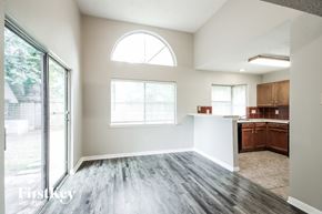 Kingwood house for rent - A spacious room with a large window and wooden flooring.