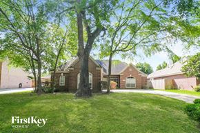 Kingwood house for rent - a large brick house with a tree in the yard