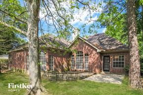 Kingwood house for rent - a brick house with trees in front of it