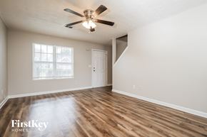 Mcdonough house for rent - A room with wooden floors and a ceiling fan.