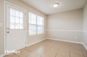 Mcdonough house for rent - A room with a white door and a window with blinds.