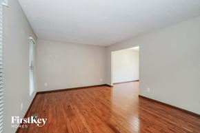 Dublin house for rent - a spacious living room with hardwood flooring and white walls