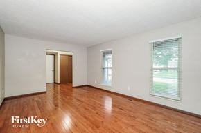 Dublin house for rent - an empty living room with wood floors and a door to a closet