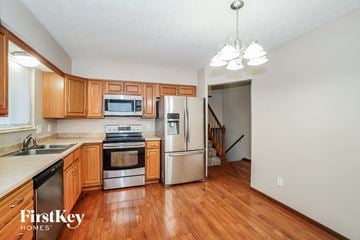 Dublin house for rent - a kitchen with wooden cabinets and stainless steel appliances