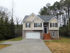 Powder Springs house for rent - the front of a house with a white garage door