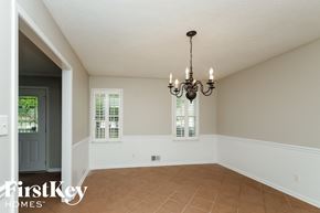 Marietta house for rent - A room with a chandelier and two windows.
